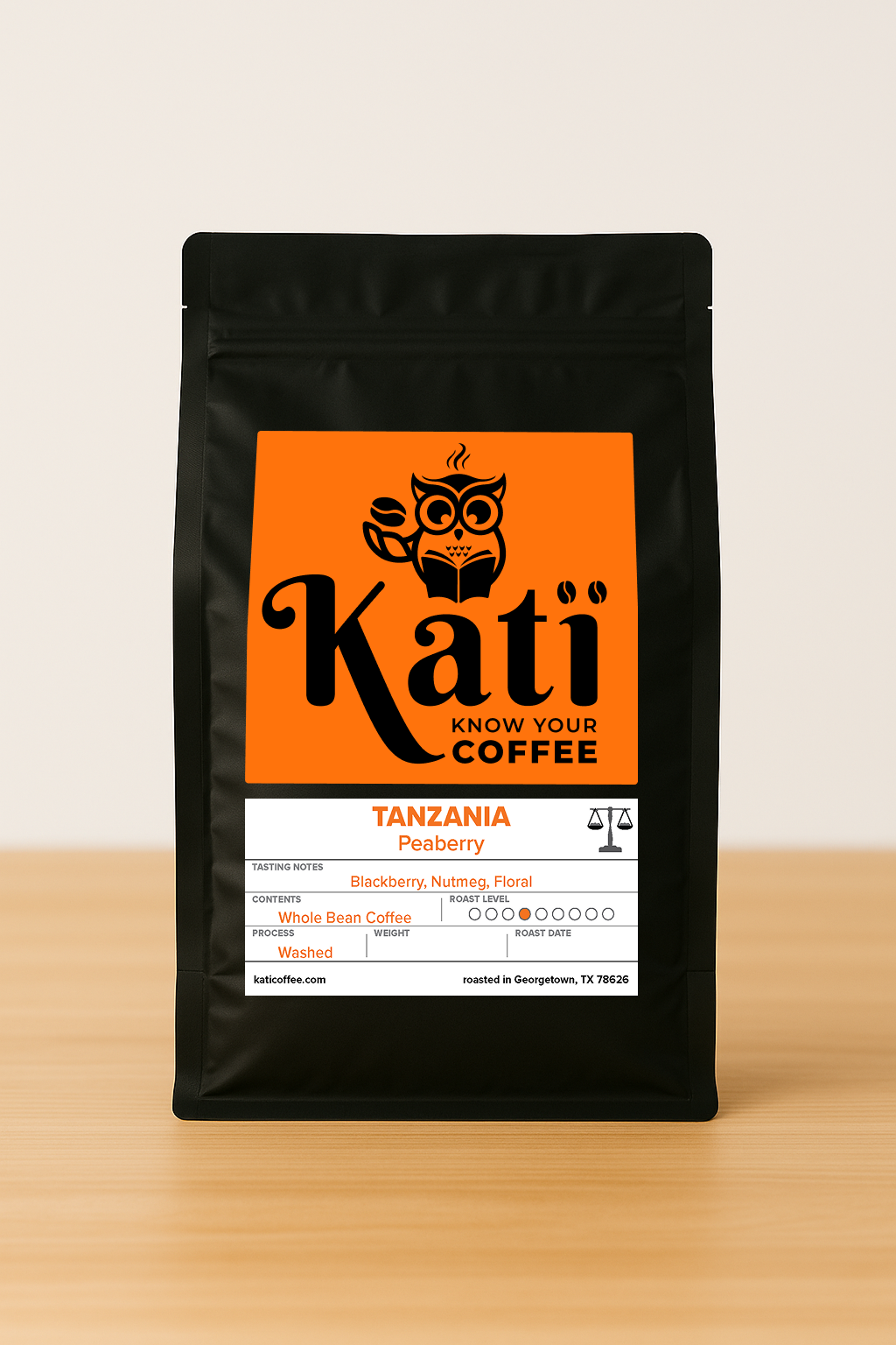 Kati coffee bag with orange label on a wooden surface